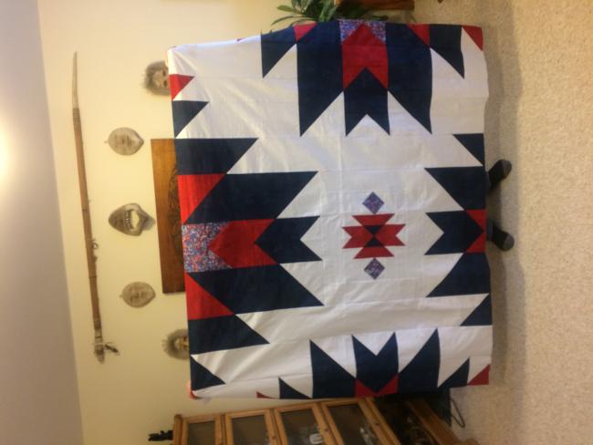 Margaret Lau's quilt is the 2020 retreat's mystery quilt that she has turned into a Quilt of Valor.